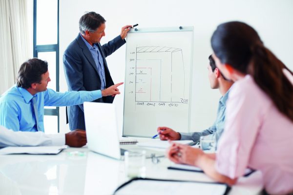 Business man pointing at chart and getting his doubts cleared during presentation